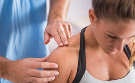 Physical therapy. Therapist addressing trapezios hombro
